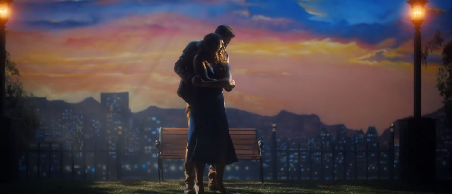 Jordan Davis and Hannah Brown dancing in front of a sunset