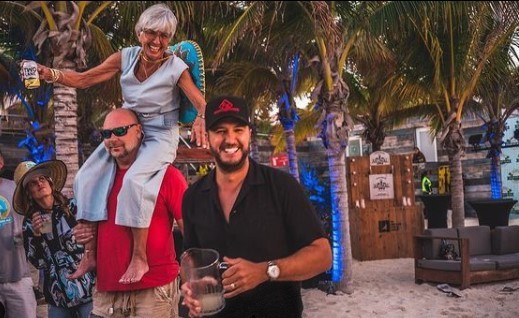 Luke Bryan and his mom dancing on a beach