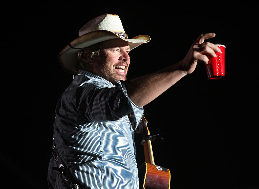 Toby Keith toasts his fans with a red solo cup, the name of one of his hit songs on the Mane Stage