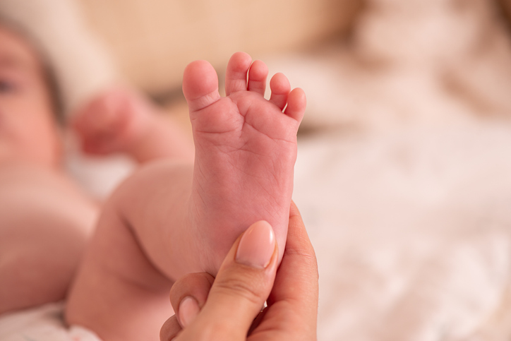 Mother Touching Baby’s Sole with Gentle Care.
